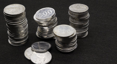 Stack of Indonesian coins isolated on black background