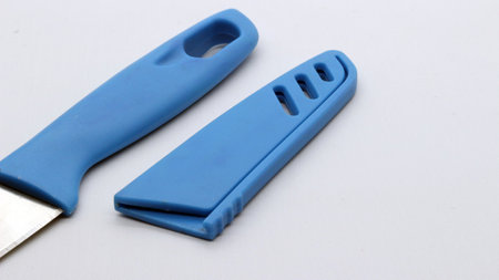 Blue knife with cover isolated on white backgroundの写真素材