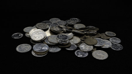 Stack of Indonesian coins isolated on black background