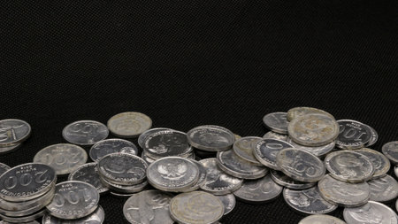 Stack of Indonesian coins isolated on black backgroundの写真素材