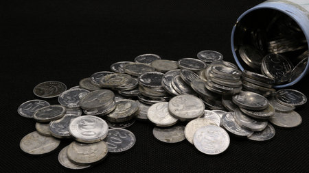 Stack of Indonesian coins isolated on black backgroundの写真素材