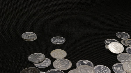 Stack of Indonesian coins isolated on black backgroundの写真素材