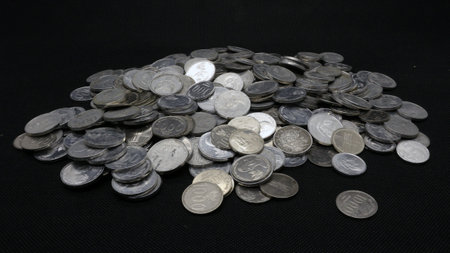 Stack of Indonesian coins isolated on black background