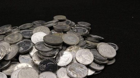 Stack of Indonesian coins isolated on black background