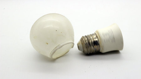 Broken white bulb isolated on white background