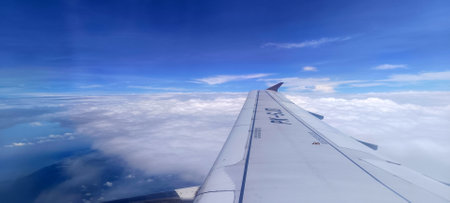 View of clouds and mountains from the airplane window seat