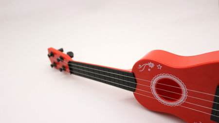 Red ukulele toy for kids isolated on white backgroundの写真素材