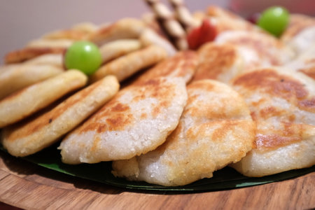 Traditional Indonesian food Wingko babat made from sticky rice flour, granulated sugar, pandan leaves and coconut milk on a plateの写真素材