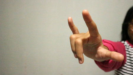 girl hand gestures making Rock & Roll Hand Symbolの写真素材