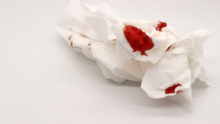 Tissue stained with red liquid isolated on white backgroundの写真素材