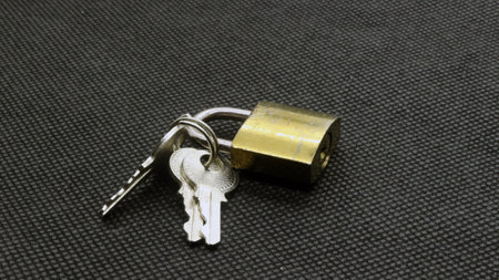 Padlock and key isolated on black background