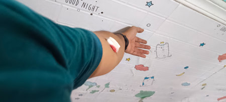 Injured male hand with adhesive bandage