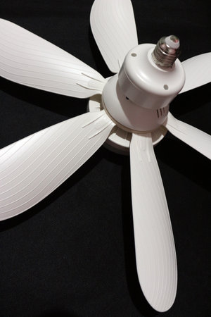 Ceiling fan with LED light and remote control isolated on black backgroundの写真素材