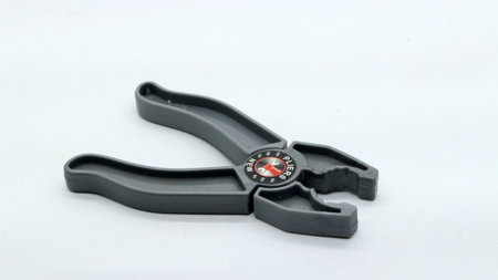 Plastic toy pliers isolated on white background