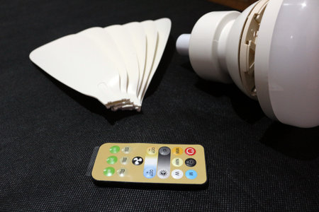 Ceiling fan with LED light and remote control isolated on black backgroundの写真素材