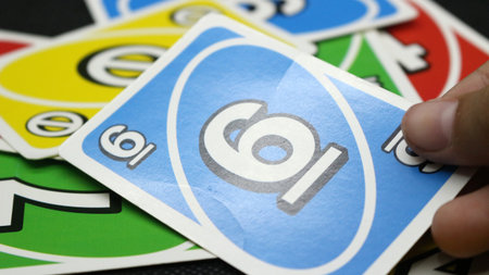 Colorful uno cards scattered on a black backgroundの写真素材