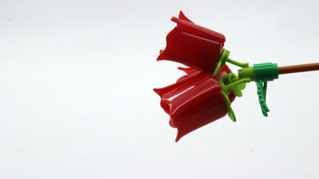 Red Plastic Flower Toy Isolated on White Backgroundの写真素材