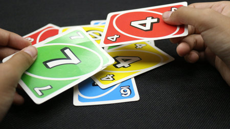 Hands playing cards on a black backgroundの写真素材