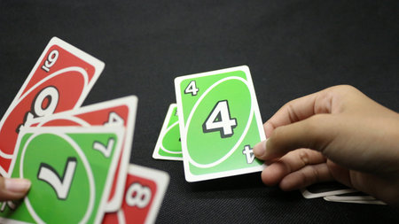 Hands playing cards on a black backgroundの写真素材