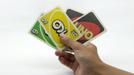 Hands playing cards on a white background