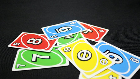 Colorful cards scattered on a black backgroundの写真素材