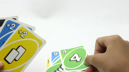 Hands playing cards on a white background