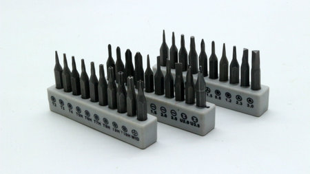 A set of screwdriver bits neatly arranged on a white background for repair tools