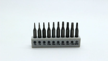 A set of screwdriver bits neatly arranged on a white background for repair tools