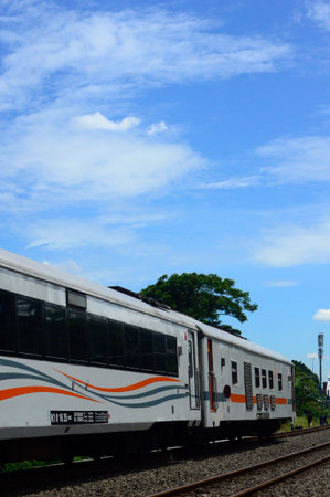 View of a train as public transportation passing along the rail line