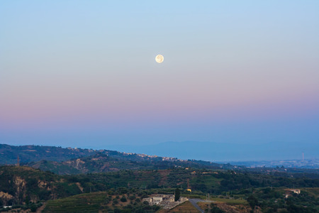Full moon perigee during sunrise in sicilyの写真素材