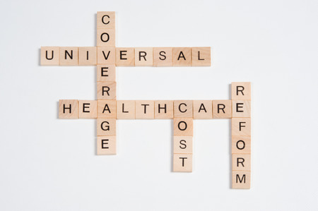 A crossword puzzle with answers regarding healthcare reform is photographed on a white background, providing plenty of copy space.の写真素材