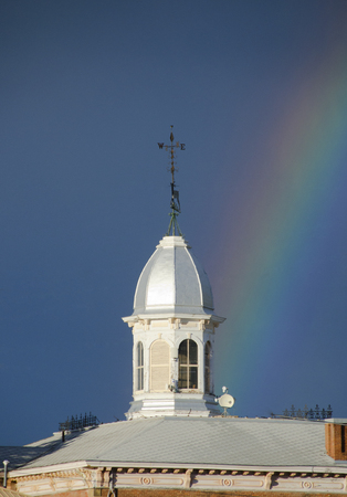 A rainbow ends at the courthouse cupola in Buena Vista, Colorado.の写真素材