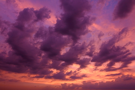 Colorful clouds of bizarre shapes at sunsetの写真素材