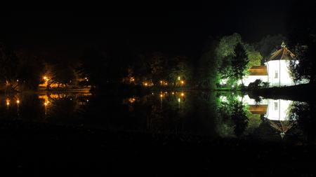 Poland, Zwierzyniec near Zamosc, Roztocze National Park, 28 September 2013 - baroque St John Nepomucen Church on Island illuminated at night and reflecting lake s waterのeditorial素材