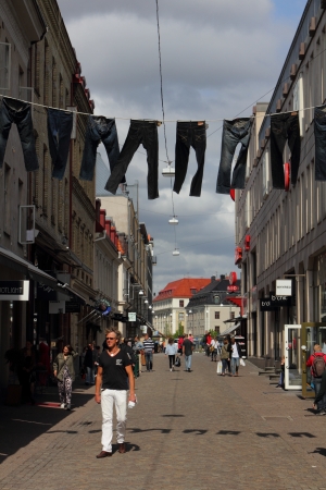 Sweden, Goteborg, 19 May 2011 - Old Town with pedestrian street and fancy stores and cafes at Södra Larmgatan with hanging trousers のeditorial素材