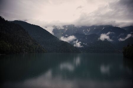 Rainy mysterious morning on a mountain lakeの写真素材
