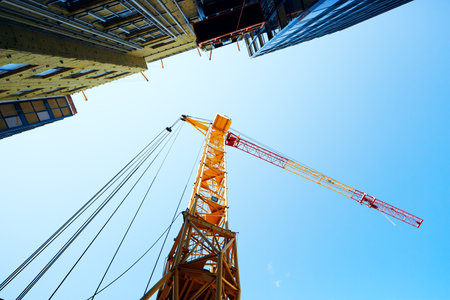 A construction crane is erecting a buildingの写真素材