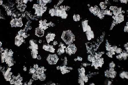 Macro shot of broken glass on black background. Shallow depth of field.の写真素材
