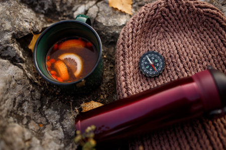 Cup of tea with lemon and a compass on the nature.