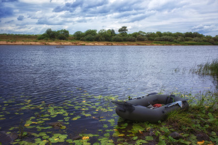Inflatable boat on the bank of the river in the summerの写真素材