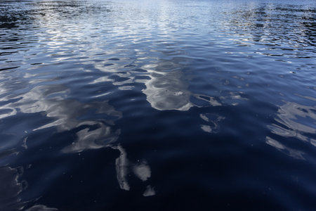 Reflection of the sky and clouds on the surface of the waterの写真素材