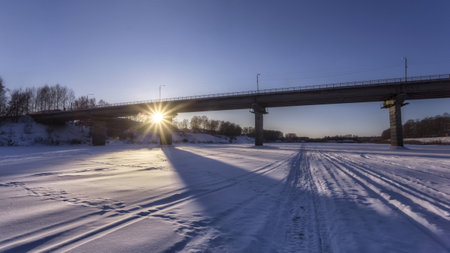 Bridge over the frozen river. winter landscape. panoramic view.の写真素材