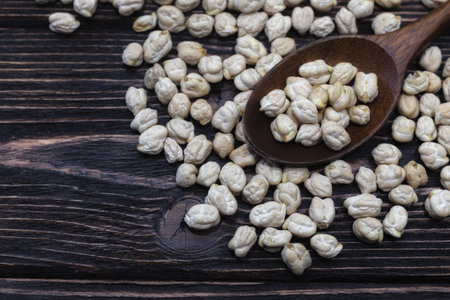 Raw chickpeas on wooden background (close-up shot)の写真素材
