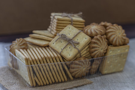 Biscuits in a glass bowl on a wooden table. Selective focus.の写真素材