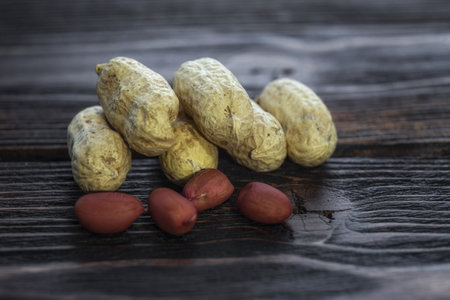 Peanuts on a wooden background. Selective focus. Shallow depth of field.