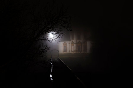 Old abandoned church at night with a full moon in the background. selective focus