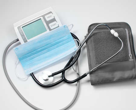 A doctor's stethoscope is used to listen to a patient's heart and lungs. An electronic device for...