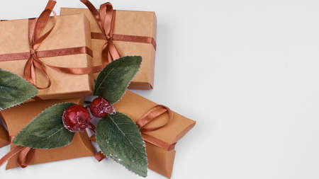 A Christmas gift. Box with brown satin ribbon on a white background. Copy spaceの写真素材