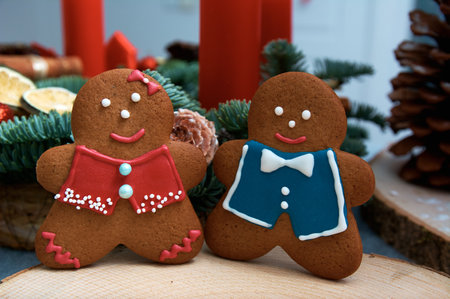 Christmas gingerbread in the shape of merry men. Christmas tree in the background.