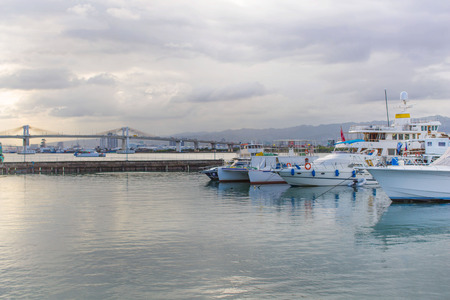 Philippines Mactan Island Yacht on a cloudy day in a tranquil scene with reflections in waterの写真素材